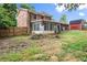 View of the home from the backyard showing a brick exterior and enclosed sunroom at 2711 Bethesda Ne Ct, Lawrenceville, GA 30044