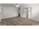 Bedroom with hardwood floors, bi-fold closet, and access to another room with a staircase at 2711 Bethesda Ne Ct, Lawrenceville, GA 30044