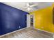 Bedroom featuring two-tone walls with a closet and door leading to a room with a ceiling fan at 2711 Bethesda Ne Ct, Lawrenceville, GA 30044