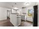 Bright eat-in kitchen with stainless steel appliances, white cabinets, granite counters, and wood-look floors at 2711 Bethesda Ne Ct, Lawrenceville, GA 30044