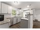 Bright eat-in kitchen with stainless steel appliances, white cabinets, granite counters, and wood-look floors at 2711 Bethesda Ne Ct, Lawrenceville, GA 30044