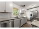Bright kitchen features stainless steel appliances, white cabinets, granite counters, and wood-look floors at 2711 Bethesda Ne Ct, Lawrenceville, GA 30044