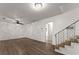 Bright living room boasts wood-look floors, a ceiling fan, and staircase at 2711 Bethesda Ne Ct, Lawrenceville, GA 30044