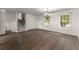 Open-concept living space with hardwood flooring, white walls, and bright natural light at 2711 Bethesda Ne Ct, Lawrenceville, GA 30044