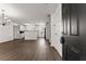 An open-concept living room and kitchen featuring hardwood floors and white cabinets at 2711 Bethesda Ne Ct, Lawrenceville, GA 30044
