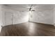 Spacious living room with wood-look floors, ceiling fan, and a large window at 2711 Bethesda Ne Ct, Lawrenceville, GA 30044