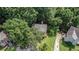 Aerial view of a home nestled among mature trees and landscaped yard in a tranquil neighborhood at 3440 Oaktree Way, Stonecrest, GA 30038