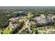 An aerial view of a commercial and residential neighborhood surrounded by dense trees and lush green spaces at 3440 Oaktree Way, Stonecrest, GA 30038