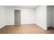 Finished basement area featuring wood-look flooring, a door, and ample space for various activities at 3440 Oaktree Way, Stonecrest, GA 30038