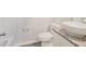 Bathroom featuring a tub, toilet, and vanity with a granite countertop and vessel sink at 3440 Oaktree Way, Stonecrest, GA 30038