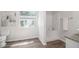 Bathroom with stand-up shower, large window, and granite countertop on the vanity at 3440 Oaktree Way, Stonecrest, GA 30038