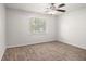 Bedroom with a ceiling fan, neutral carpet, large window providing natural light at 3440 Oaktree Way, Stonecrest, GA 30038