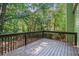 A charming deck provides a relaxing space for outdoor enjoyment, surrounded by lush greenery at 3440 Oaktree Way, Stonecrest, GA 30038