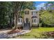 Charming two-story brick home with bay windows, fresh landscaping, and a welcoming staircase at 3440 Oaktree Way, Stonecrest, GA 30038