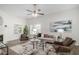 Comfortable living room features large windows, a fireplace, neutral decor, and stylish furnishings at 3440 Oaktree Way, Stonecrest, GA 30038
