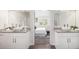 Double vanity in the main bathroom with granite counters and vessel sinks, leading into the main bedroom at 3440 Oaktree Way, Stonecrest, GA 30038