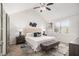 Bright main bedroom with a vaulted ceiling, ceiling fan, modern decor, and a large window at 3440 Oaktree Way, Stonecrest, GA 30038