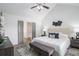 Bright main bedroom with a vaulted ceiling, ceiling fan, modern decor, and a large window at 3440 Oaktree Way, Stonecrest, GA 30038