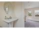 Powder room with a pedestal sink, modern fixtures, neutral walls, and tile floors at 1066 Brandsford Nw St, Atlanta, GA 30318