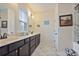 Bathroom boasts a double vanity with marble countertop, tile floors, and modern fixtures at 1066 Brandsford Nw St, Atlanta, GA 30318