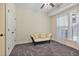 Bright bedroom features neutral paint, cozy carpet, a ceiling fan, and bright window with flowing curtains at 1066 Brandsford Nw St, Atlanta, GA 30318