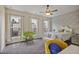 Inviting bedroom featuring three large windows, a ceiling fan, and a cozy brick accent wall at 1066 Brandsford Nw St, Atlanta, GA 30318