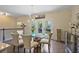 Dining area featuring hardwood floors, a modern chandelier, and access to the kitchen at 1066 Brandsford Nw St, Atlanta, GA 30318