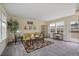 Cozy living room featuring large windows, neutral walls, carpeted floors, and stylish decor at 1066 Brandsford Nw St, Atlanta, GA 30318
