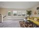 Bright living room featuring large windows, carpeted floors, neutral walls, and access to deck at 1066 Brandsford Nw St, Atlanta, GA 30318