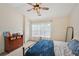 A bright bedroom with carpeted floors, a ceiling fan, and large window offers comfort and style at 2084 Del Lago Nw Cir # 1, Kennesaw, GA 30152