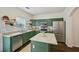 A kitchen features stainless steel appliances, a central island, green cabinetry, and granite countertops at 2084 Del Lago Nw Cir # 1, Kennesaw, GA 30152