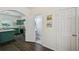 A kitchen featuring green cabinets, stainless steel appliances, and an open design leads to a bright, modern space at 2084 Del Lago Nw Cir # 1, Kennesaw, GA 30152