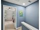 The landing features blue walls, while a bedroom offers natural light through window views at 2084 Del Lago Nw Cir # 1, Kennesaw, GA 30152