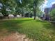 A large grassy backyard offers ample space, mature trees, and a wooden fence at 2206 Rhett Ct, Lawrenceville, GA 30044