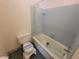 Compact bathroom with a shower-tub combo and toilet, providing essential amenities in a practical layout at 2206 Rhett Ct, Lawrenceville, GA 30044