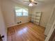 Bright bedroom with hardwood floors, ceiling fan, and plenty of natural light from the window at 2206 Rhett Ct, Lawrenceville, GA 30044