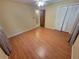 Cozy bedroom with hardwood floors, ceiling fan, and white louvered closet doors at 2206 Rhett Ct, Lawrenceville, GA 30044