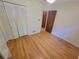 Bedroom with hardwood floors, ceiling fan, and louvered closet doors at 2206 Rhett Ct, Lawrenceville, GA 30044
