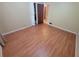 Cozy bedroom featuring hardwood floors, neutral walls, and open closet at 2206 Rhett Ct, Lawrenceville, GA 30044