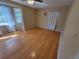 Sunny bedroom featuring hardwood floors, neutral walls, and multiple windows, creating a bright and airy atmosphere at 2206 Rhett Ct, Lawrenceville, GA 30044
