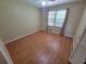 Bright bedroom with hardwood floors, natural light from the window, and a ceiling fan at 2206 Rhett Ct, Lawrenceville, GA 30044