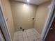 A utility room with tile flooring and washer and dryer hookups awaits your appliances at 2206 Rhett Ct, Lawrenceville, GA 30044