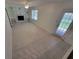 Open living room with a decorative fireplace, built-in shelving, and bright windows creating a cozy and inviting atmosphere at 2206 Rhett Ct, Lawrenceville, GA 30044