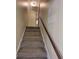 Carpeted staircase with wooden banister and neutral walls connecting the different levels of the house at 2206 Rhett Ct, Lawrenceville, GA 30044