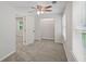 This bedroom features neutral walls, a ceiling fan, carpet, and a closet for ample storage at 5160 W Chapel Hill Rd, Douglasville, GA 30135