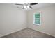 This bedroom features neutral walls, carpet, a ceiling fan, and a window at 5160 W Chapel Hill Rd, Douglasville, GA 30135
