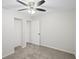 This bedroom features neutral walls, carpet, a ceiling fan, a closet and a door at 5160 W Chapel Hill Rd, Douglasville, GA 30135