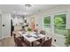 Bright kitchen with white cabinets, granite countertops, black appliances, and stylish luxury vinyl plank flooring at 5160 W Chapel Hill Rd, Douglasville, GA 30135