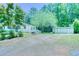 Charming exterior view of this home featuring a spacious yard and a shed at 5160 W Chapel Hill Rd, Douglasville, GA 30135