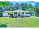 Charming single-story home with a well-maintained lawn, inviting front porch, and beautiful surrounding trees at 5160 W Chapel Hill Rd, Douglasville, GA 30135